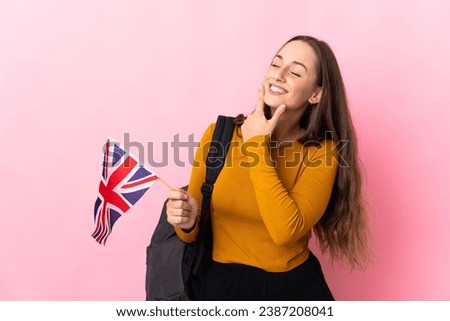 Young hispanic woman holding an United Kingdom flag happy and smiling