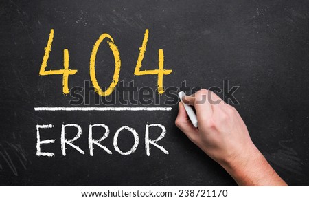 hand writing 404 error on a chalk board