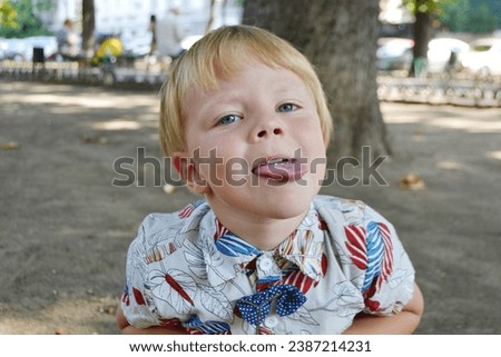 Blond boy 4 years old playing on a children playground and has fun. High quality photo.