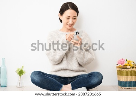 Lifestyle image of a young woman operating a smartphone