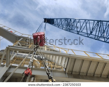 the process of lifting goods using a hook hanging from the crane boom