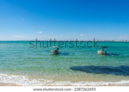 Hammamet Tunisia, Beach and  boats on shallow water, view on Mediterranean sea  Royalty-Free Stock Photo #2387262693