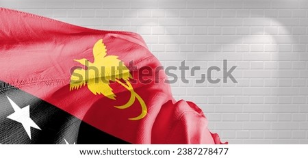 Papua New Guinea national flag cloth fabric waving on beautiful light Background.