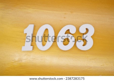 The golden yellow painted wood panel for the background, number 1063, is made from white painted wood.