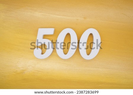 The golden yellow painted wood panel for the background, number 500, is made from white painted wood.