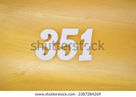 The golden yellow painted wood panel for the background, number 351, is made from white painted wood.