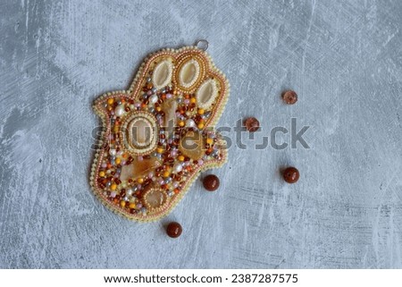 Handmade jewelry on a light gray background with copy space. Jewelry made of beads.