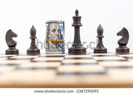 Close-up view on chess board with one line of black figures, American dollars rolled and placed instead of black queen. Concept of business strategy, stock market and competition. High quality photo