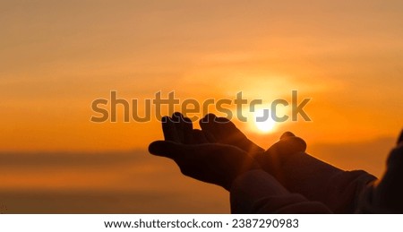 Silhouette of woman kneeling down praying for worship God at sky background. Christians pray to jesus christ for calmness. In morning people got to a quiet place and prayed. copy space. Royalty-Free Stock Photo #2387290983