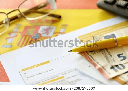 Modelo 200 spanish tax form for corporate income tax for non resident taxpayer lies on flag of Spain close up on accountant table Royalty-Free Stock Photo #2387293509