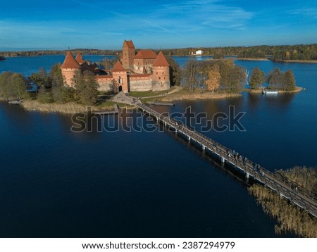 Drone picture of Trakai castle surrounded by lake Galve (Galvė) with a bridge leading up to it located in Trakai, Lithuania