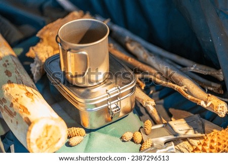 Outdoor kitchen equipment camp fire and brewing tea pot moka coffee drip cup,with wooden table camping gas stove set in nature outdoor,mountain background,concept camp and travel Royalty-Free Stock Photo #2387296513