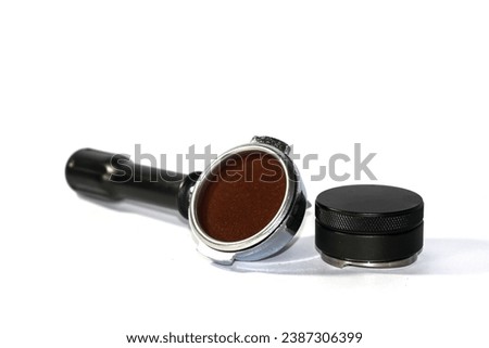 Portafilter, coffee powder, and tamper put on white background. Concept equipment of barista makes coffee by espresso machines. Royalty-Free Stock Photo #2387306399