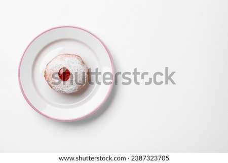 Hanukkah donut with jelly and powdered sugar on white background, top view. Space for text