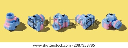 Colorful toy camera on pastel color background, isometric view