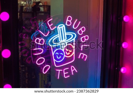 Bubble tea neon sign pink with blue color glow on cafe window . menu cafe decoration
