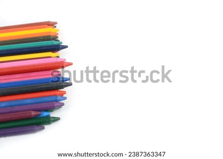 Crayons lined up isolated on white background.