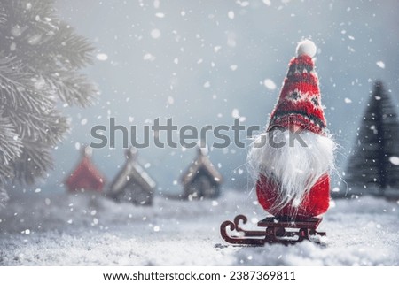 a Christmas gnome on a sled in the snow. New Year's, Christmas background with copy space
