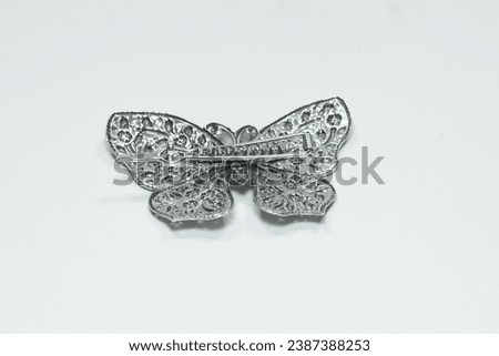 Silver butterfly hair clip on white background Royalty-Free Stock Photo #2387388253