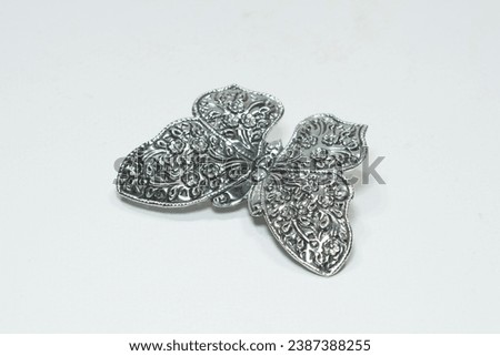 Silver butterfly hair clip on white background Royalty-Free Stock Photo #2387388255