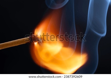 a wooden safety matchstick burning  Royalty-Free Stock Photo #2387392609