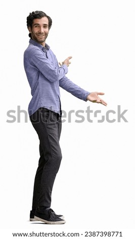 young man in full growth. isolated on white background demonstrates with hands