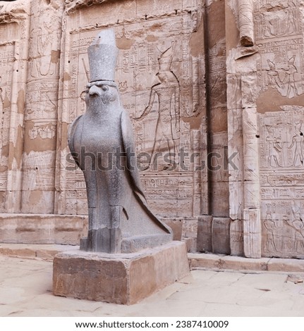 Granite statue of God Horus falcon at entrance Temple of Horus, Edfu, Egypt. Famous landmark ptolemaic Horus Temple in Idfu (Edfou, Behdet), Egypt Royalty-Free Stock Photo #2387410009