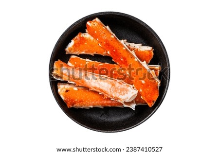 Alaskan King Crab legs Phalanx in a pan with herbs. Isolated, white background. Top view. Royalty-Free Stock Photo #2387410527