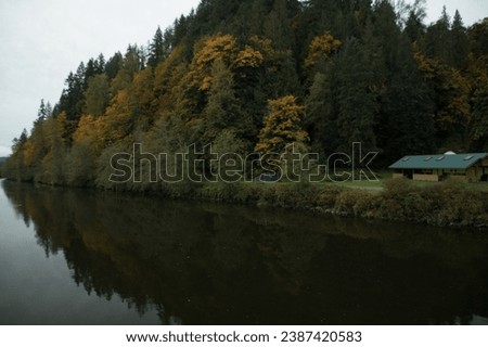 Snoqualmie river banks during fall season with bridge and Tiger Mountain in the background, Carnation, Washington