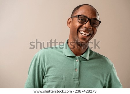 Man wearing glasses smiling on pastel background. Royalty-Free Stock Photo #2387428273