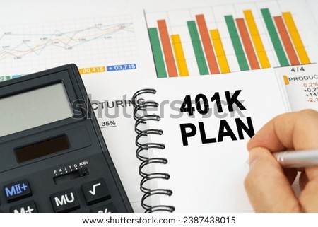 Business concept. There is a calculator on the table, business charts, a man made a note in a notebook - 401K PLAN