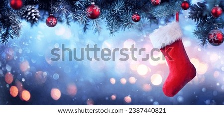 Stocking Hanging Christmas Tree - Red Sock With Snow And Bokeh Lights Royalty-Free Stock Photo #2387440821