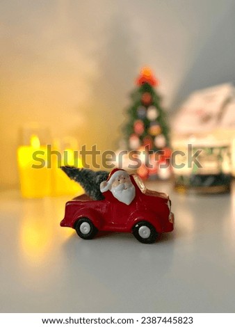 Christmas decoration santa claus in a car with christmas tree