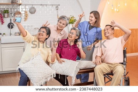 Portrait happy elderly people, smiling with happiness, making selfie photography together, sitting in indoor cozy nursing home, community. Retirement, Healthcare Concept