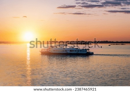 Cruise on the river. Cruise liner in the sunset. Romantic sunset on the Volga and Oka rivers. Strelka in Nizhny Novgorod.