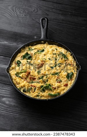 Creamy spaghetti squash pasta with parmesan cheese and sun dried tomato sauce in iron cast pan Royalty-Free Stock Photo #2387478343