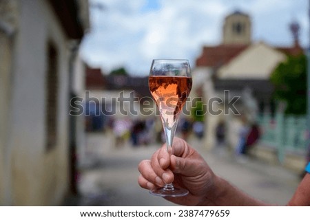 Tasting of sparkling rose wine with bubbles champagne on summer weekend festival route of champagne in Celles-sur-Ource, Cote des Bar, Champagne region, France Royalty-Free Stock Photo #2387479659