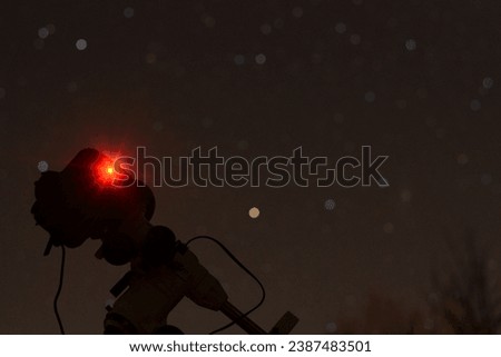 Astronomy setup in search of Andromeda Galaxy. Night sky 
photography.