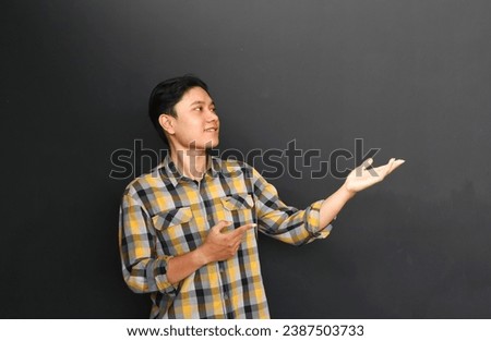  Portrait of asian young man with both hands presenting something