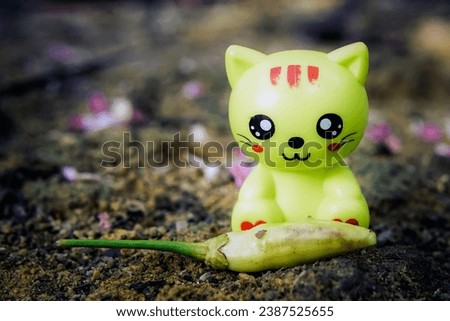 Miniature cat doll with yellow color and black eyes