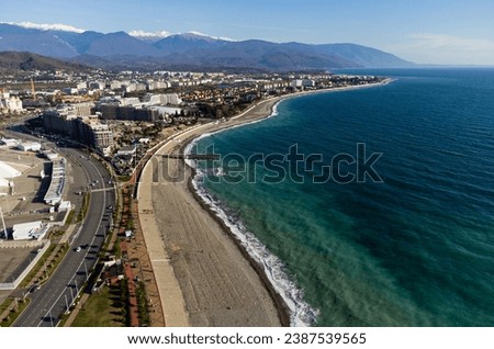 Sochi cityscape and Black sea shore from aerial view. Adler district from above. Resort town in the Caucasus mountains. Royalty-Free Stock Photo #2387539565