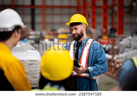 Gather a group of young engineers in the metal sheet factory. Discuss goals and work methods from your supervisor or co-workers. Professionally and happily