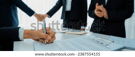 Two business executive shake hand in boardroom, sealing agreement merging two company. Handshake symbolize business partnership and cooperation. Corporate acquisition and merger concept. Shrewd Royalty-Free Stock Photo #2387554155