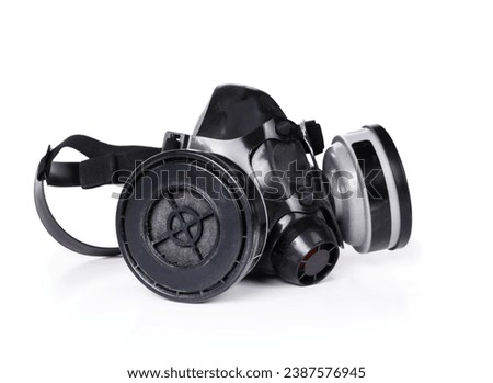 Isolated half gas mask with cartridge filter also know as half-mask respirator. Used to air purify and protect from dust, smoke, fumes and vapors. Medical grade work protection. White background. Royalty-Free Stock Photo #2387576945