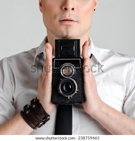 Business man holding rarity old photographic camera closeup