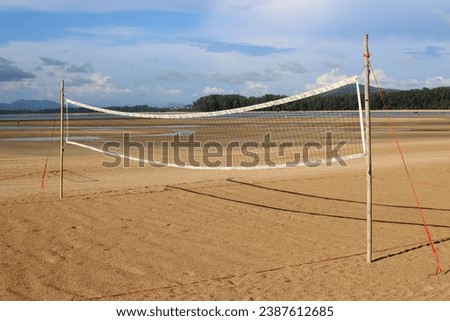 photo of an empty beach volley court with its net or playground on the sand with no sport players under a nice sunny weather 