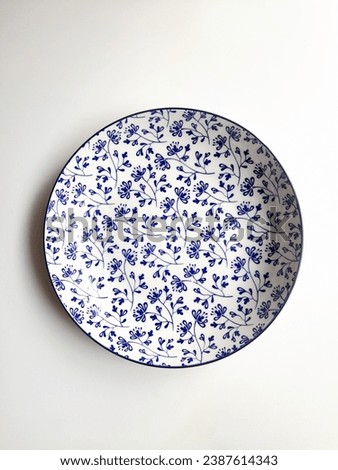 Plate on white background and art pattern wallpaper 