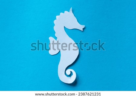 sea horse paper cut isolated on blue