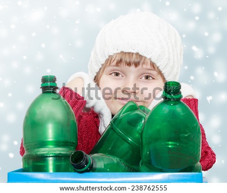 cute young girl with plastic bottles on winter background - waste sorting theme