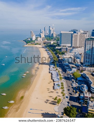 Pattaya Thailand, a view of the beach road with hotels and skyscrapers buildings alongside the renovated new beach road. Drone aerial view of the beach of Pattaya Royalty-Free Stock Photo #2387626147